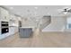 Open concept showcasing the kitchen's gray island, stainless appliances, and its easy flow to the staircase at 159 Sunshower Rdg, Canton, GA 30114