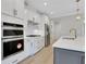 Well-equipped kitchen showcasing built-in ovens, a gas cooktop, and white countertops with gray cabinetry at 159 Sunshower Rdg, Canton, GA 30114