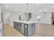 Open-concept kitchen featuring a central island, stainless appliances, and seamless access to adjacent living areas at 159 Sunshower Rdg, Canton, GA 30114