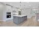 Modern kitchen featuring white cabinets, a gray island, stainless steel appliances, and sleek pendant lights at 159 Sunshower Rdg, Canton, GA 30114