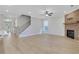 Open-concept design with a fireplace, light hardwood floors, staircase, and a glimpse of the front entrance at 159 Sunshower Rdg, Canton, GA 30114