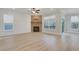 Spacious living room with a brick fireplace, two windows, and a door for outdoor access at 159 Sunshower Rdg, Canton, GA 30114