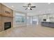 Open-concept living room featuring a brick fireplace, large windows, and light hardwood floors at 159 Sunshower Rdg, Canton, GA 30114