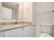 Bathroom featuring granite vanity, toilet, and large mirror and modern fixtures at 277 Ralph David Abernathy Blvd, Atlanta, GA 30312