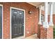 Close-up of the front door with brick surround and classic columns at 277 Ralph David Abernathy Blvd, Atlanta, GA 30312