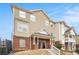 View of two-story townhouse with brick accents and landscaped front yard at 277 Ralph David Abernathy Blvd, Atlanta, GA 30312