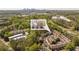 Aerial view showcasing townhouses nestled among lush trees with a cityscape backdrop, highlighting the property's serene location at 2827 Overlook Ne Trce, Atlanta, GA 30324