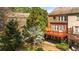 A multi-level deck sits behind this brick townhome in a backyard framed by mature trees at 2827 Overlook Ne Trce, Atlanta, GA 30324