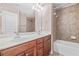 Bathroom featuring double sink vanity, shower over tub and tile flooring at 2827 Overlook Ne Trce, Atlanta, GA 30324