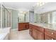 Bathroom featuring dual vanities, granite countertops, and a shower with glass door, offering space and luxury at 2827 Overlook Ne Trce, Atlanta, GA 30324