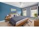 Bedroom featuring blue walls, ceiling fan and two windows at 2827 Overlook Ne Trce, Atlanta, GA 30324