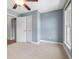 Bedroom featuring neutral carpet, calming blue walls, a ceiling fan, and natural light from a nearby window at 2827 Overlook Ne Trce, Atlanta, GA 30324