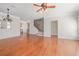 Open-concept living room with hardwood floors, elegant lighting, and stairs leading to upper level at 2827 Overlook Ne Trce, Atlanta, GA 30324