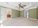 Main bedroom featuring an ensuite bathroom, ceiling fan, and neutral carpet, creating a peaceful retreat at 2827 Overlook Ne Trce, Atlanta, GA 30324