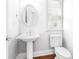 Powder room featuring pedestal sink, hardwood floors, and a classic design for a stylish and functional space at 2827 Overlook Ne Trce, Atlanta, GA 30324