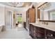 Elegant bathroom with double vanity, granite counters, chandelier, and tile flooring at 4030 Palisades Main Nw, Kennesaw, GA 30144