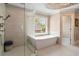Bright bathroom featuring a soaking tub, seamless glass shower and contemporary fixtures at 4030 Palisades Main Nw, Kennesaw, GA 30144