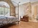 Bedroom with a four poster bed, arched window, and ensuite bathroom at 4030 Palisades Main Nw, Kennesaw, GA 30144