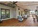 Covered wooden deck featuring comfortable outdoor seating, ceiling fans, and lighting at 4030 Palisades Main Nw, Kennesaw, GA 30144