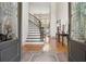 Grand foyer showcases a curved staircase, beautiful floors and elegant chandelier at 4030 Palisades Main Nw, Kennesaw, GA 30144