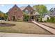 Charming brick home features a well-manicured lawn and meticulously maintained landscaping at 4030 Palisades Main Nw, Kennesaw, GA 30144