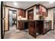 Traditional kitchen with dark wood cabinets, black countertops, and tile floors at 4030 Palisades Main Nw, Kennesaw, GA 30144