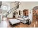 Elegant living room showcasing curved staircase, hardwood floors, and open access to the kitchen at 4030 Palisades Main Nw, Kennesaw, GA 30144