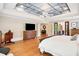 Spacious primary bedroom featuring tray ceilings, hardwood floors, and a view into the ensuite bathroom at 4030 Palisades Main Nw, Kennesaw, GA 30144