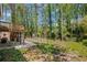 Landscaped backyard features a deck, patio, storage shed, and mature trees for privacy at 4232 Rue Saint Dominique, Stone Mountain, GA 30083