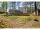 View of the back of the home featuring a deck, patio, storage shed, and fenced yard at 4232 Rue Saint Dominique, Stone Mountain, GA 30083