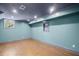 Finished basement with wood flooring, recessed lighting, and aqua colored walls at 4232 Rue Saint Dominique, Stone Mountain, GA 30083