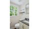 Powder room with vanity, mirror, and a window providing natural light at 4232 Rue Saint Dominique, Stone Mountain, GA 30083