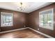 Bedroom with hardwood floors, neutral walls, and dual windows that provide ample light at 4232 Rue Saint Dominique, Stone Mountain, GA 30083