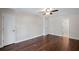 Spacious bedroom with hardwood floors, ceiling fan, and doors to an ensuite bathroom at 4232 Rue Saint Dominique, Stone Mountain, GA 30083