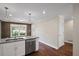 Bright, white kitchen with stainless steel appliances and open view of the living area at 4232 Rue Saint Dominique, Stone Mountain, GA 30083