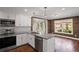 Modern kitchen with stainless appliances, grey countertops and wood paneling in an open layout at 4232 Rue Saint Dominique, Stone Mountain, GA 30083