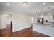 View of the white kitchen with stainless appliances and island overlooking the hardwood floors at 4232 Rue Saint Dominique, Stone Mountain, GA 30083