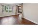 Bright living room featuring hardwood floors, a large window, and an entry to another room at 4232 Rue Saint Dominique, Stone Mountain, GA 30083