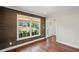 Cozy living room featuring hardwood floors, wood paneled accent wall, and natural light at 4232 Rue Saint Dominique, Stone Mountain, GA 30083