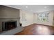 Living room with brick fireplace, hardwood floors, and window with natural light at 4232 Rue Saint Dominique, Stone Mountain, GA 30083