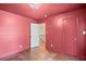 Red painted main bedroom featuring hardwood floors and a closet at 4232 Rue Saint Dominique, Stone Mountain, GA 30083