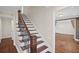 Bright foyer featuring a wooden staircase with decorative iron railing and hardwood floors at 4232 Rue Saint Dominique, Stone Mountain, GA 30083