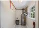 Utility room with water heater, painted walls, and a small window at 4232 Rue Saint Dominique, Stone Mountain, GA 30083