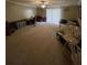 Spacious bedroom with a ceiling fan, neutral carpet, and ample room for activities at 6650 George Ct, Cumming, GA 30041