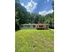 Charming single-story home featuring a red deck and a lush, green front yard at 6650 George Ct, Cumming, GA 30041