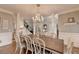 Elegant dining room featuring a chandelier, hardwood floors, and classic décor at 7050 Redcliff Ct, Suwanee, GA 30024