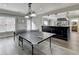 An entertainment area with a ping pong table features access to a bar area and backyard access at 7050 Redcliff Ct, Suwanee, GA 30024