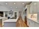 Modern kitchen features stainless steel appliances, center island with gas range, and custom cabinetry at 7050 Redcliff Ct, Suwanee, GA 30024