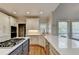 Gourmet kitchen features white cabinets, stainless steel appliances, and granite countertops at 7050 Redcliff Ct, Suwanee, GA 30024