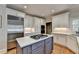Modern kitchen with stainless steel refrigerator, quartz countertops, and custom cabinets at 7050 Redcliff Ct, Suwanee, GA 30024